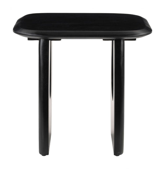 Zuo Arasan black accent table featuring a sleek design with a round top and modern legs in a stylish living space.